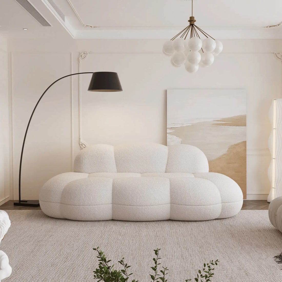 Modern living room with a cloud-shaped white sofa, floor lamp, and abstract painting.